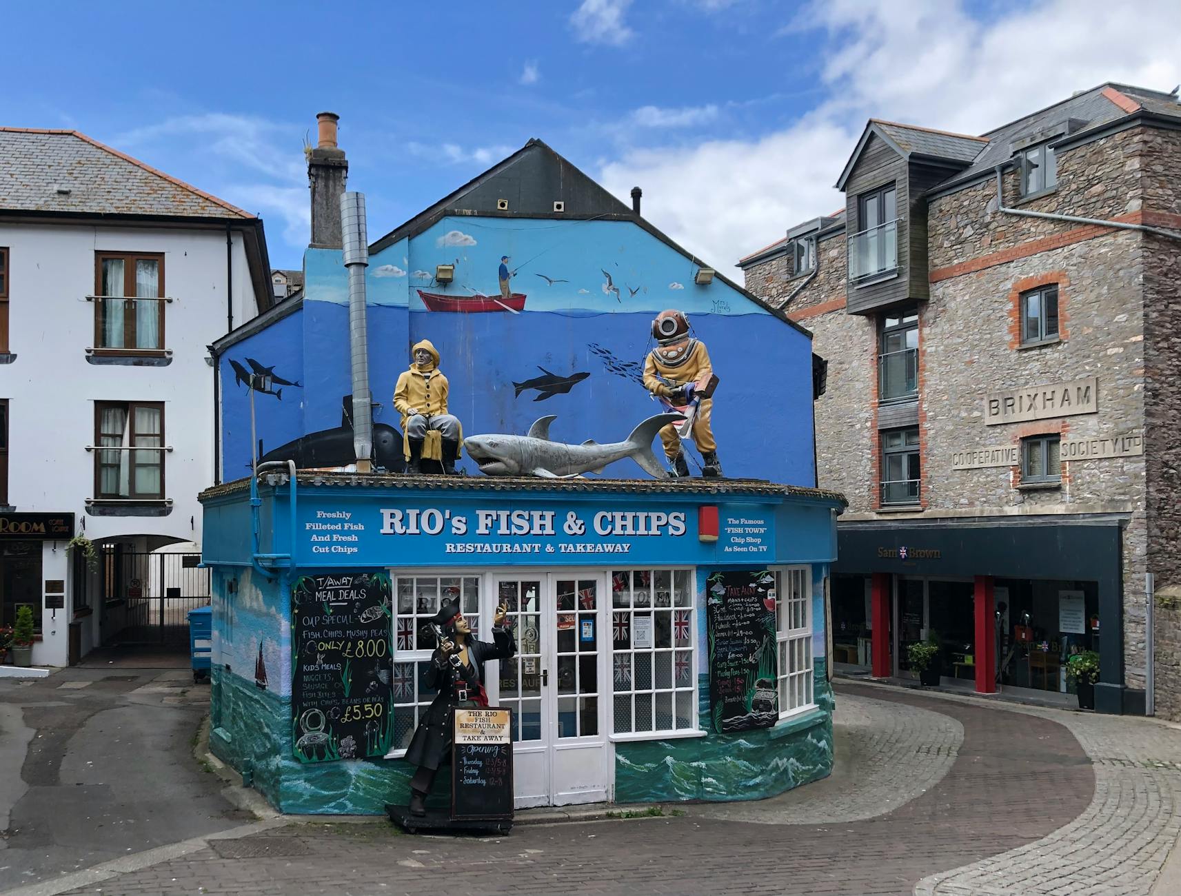 Kolorowa fasada baru rybnego z marynistycznym muralem nad morzem